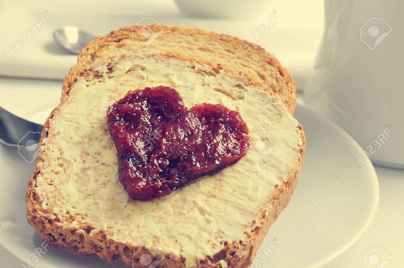 Stock photograph of buttered toast with a heart drawn in jam, covered in 123RF watermarks